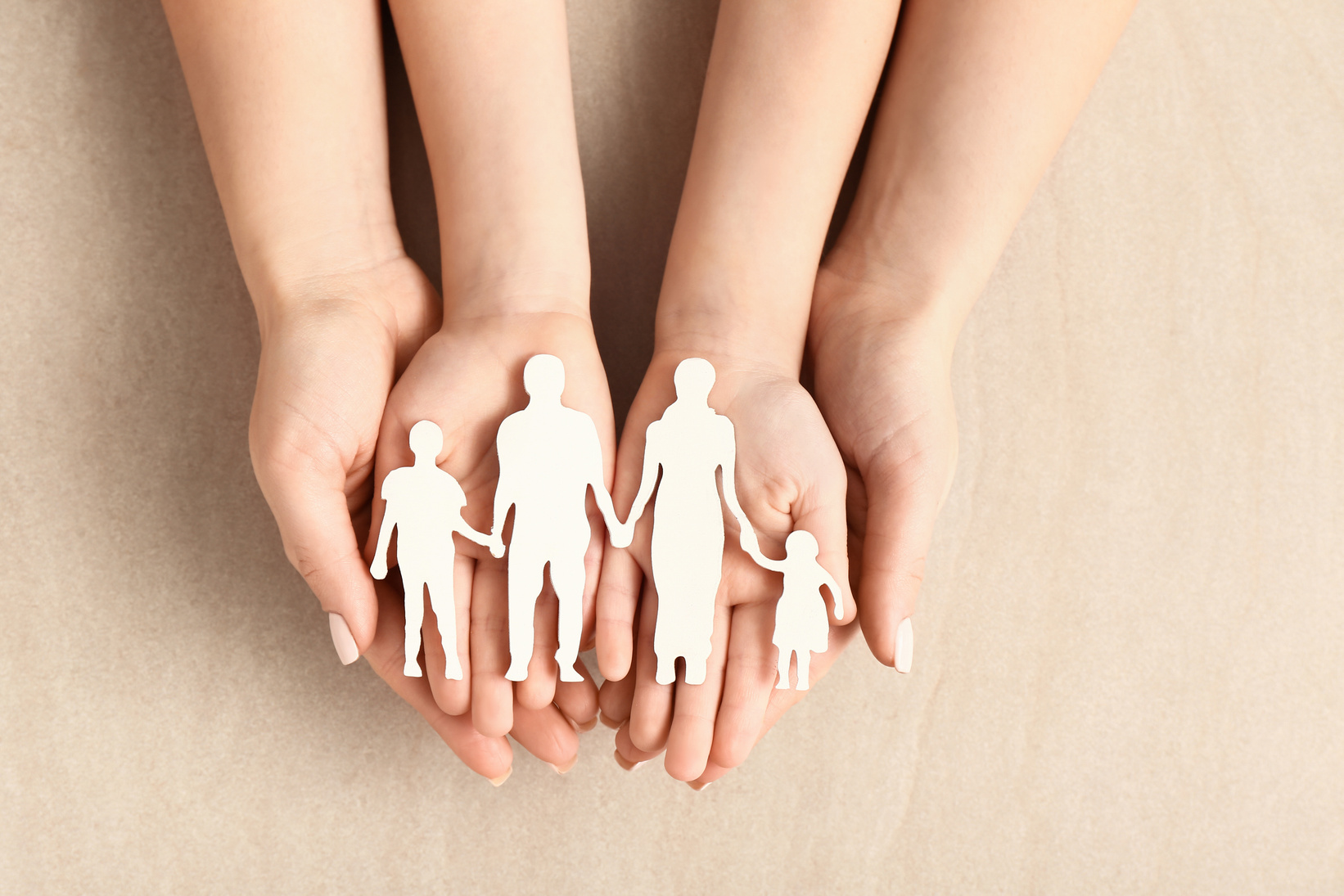 Hands of Woman and Child with Figure of Family on Light Background. Adoption Concept